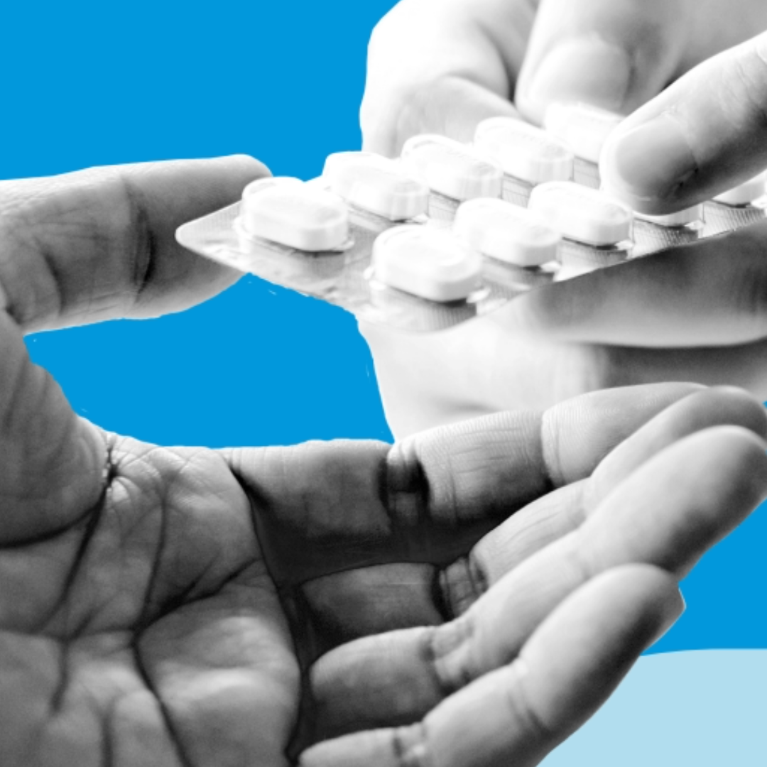 Pills are passed between two hands